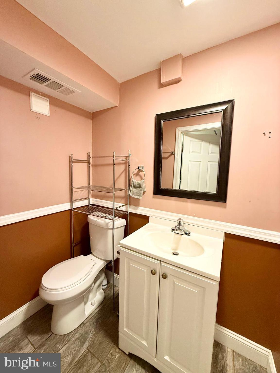 1498 Key Parkway Frederick, MD 21702 - Photo 21 of 28 a bathroom with a toilet a sink and mirror