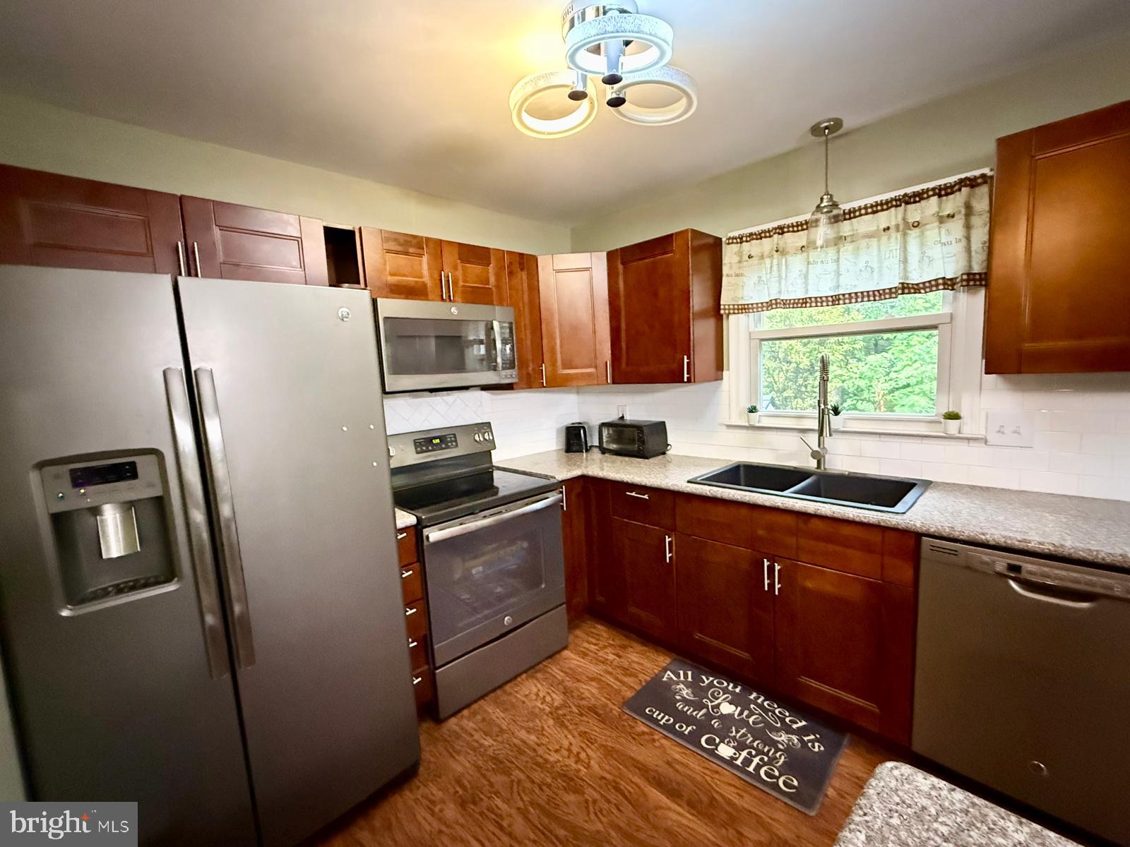 1498 Key Parkway Frederick, MD 21702 - Photo 6 of 28 a kitchen with stainless steel appliances granite countertop a refrigerator a stove a sink and a microwave