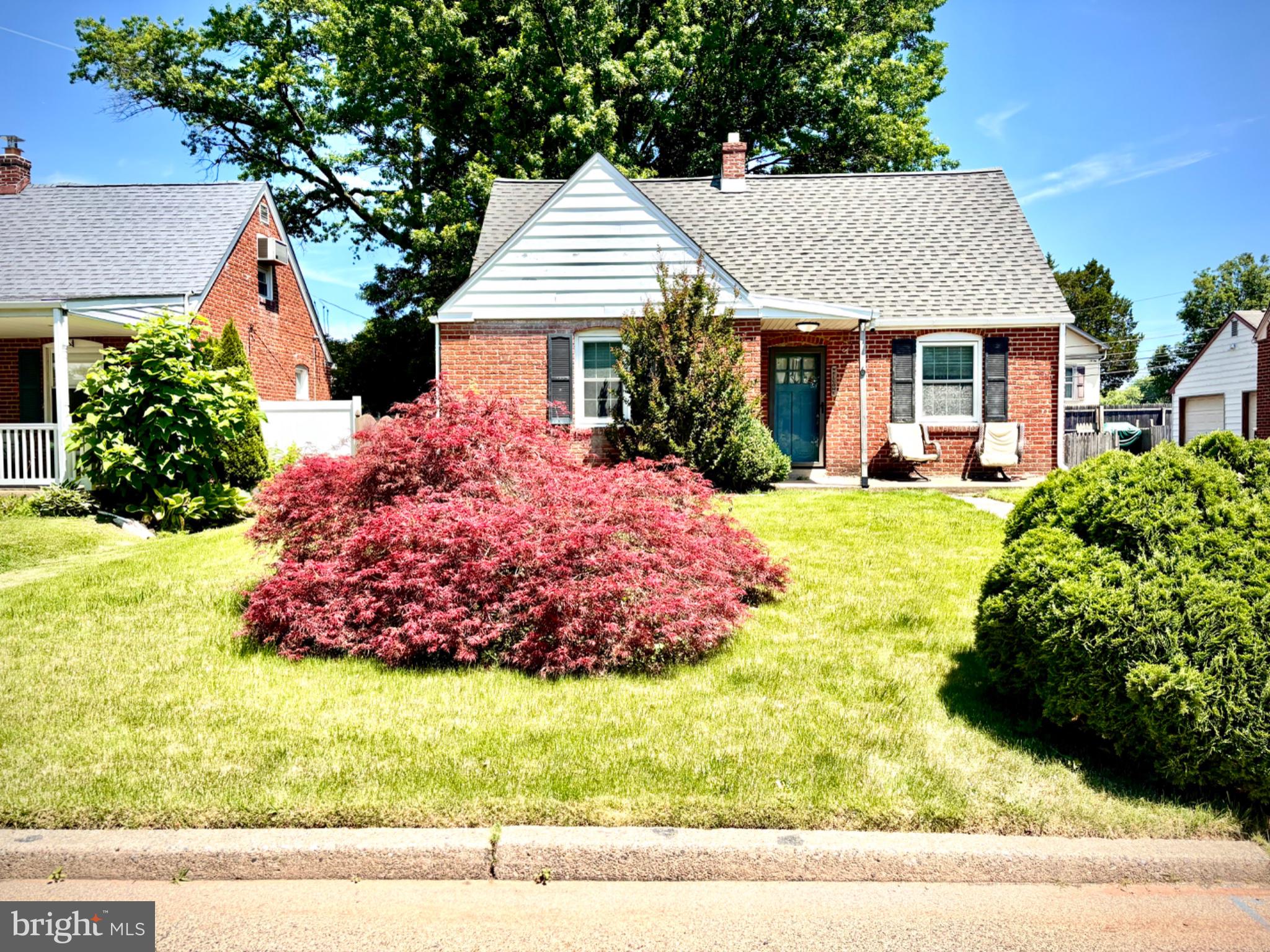 Charming brick home with vibrant garden.