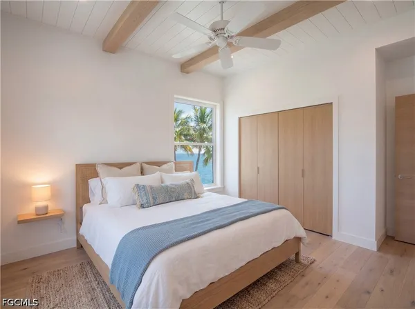 a bedroom with a large bed and a chandelier