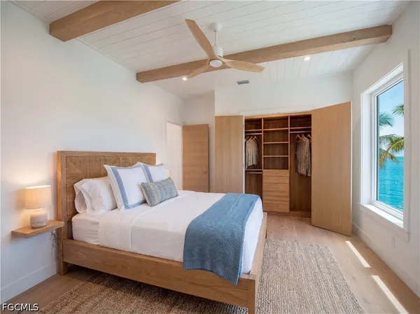 a bedroom with a large bed closet and a window