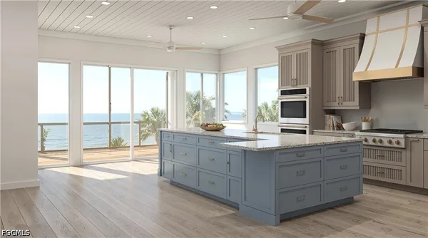 a kitchen with stainless steel appliances granite countertop a sink a stove and a wooden floors