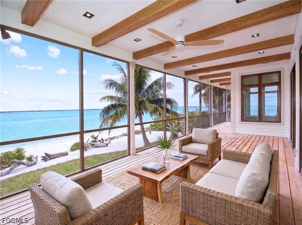 a living room with furniture and a floor to ceiling window