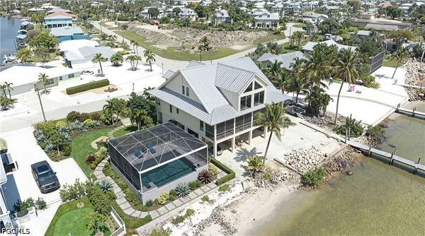 an aerial view of a house with a ocean view