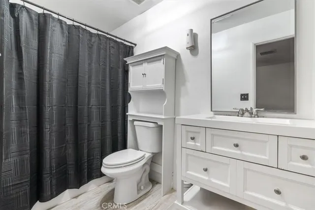 a bathroom with a toilet a sink and a mirror