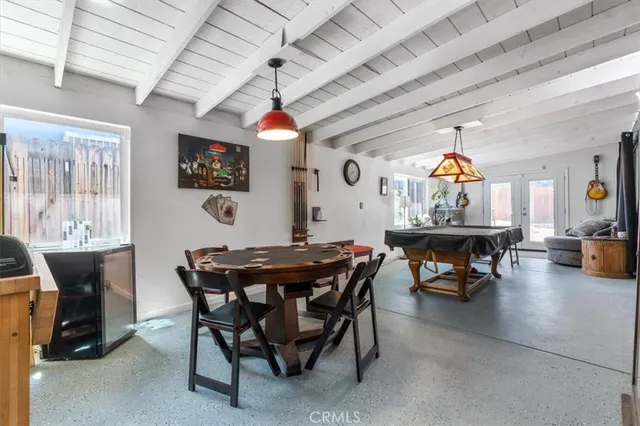 a view of a dining room with furniture and a chandelier