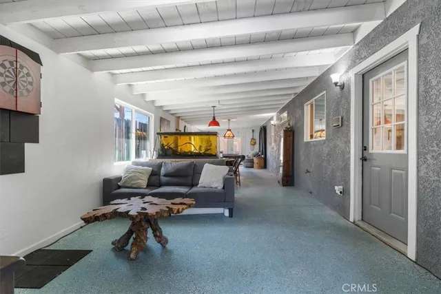 a view of a livingroom with workspace and a window