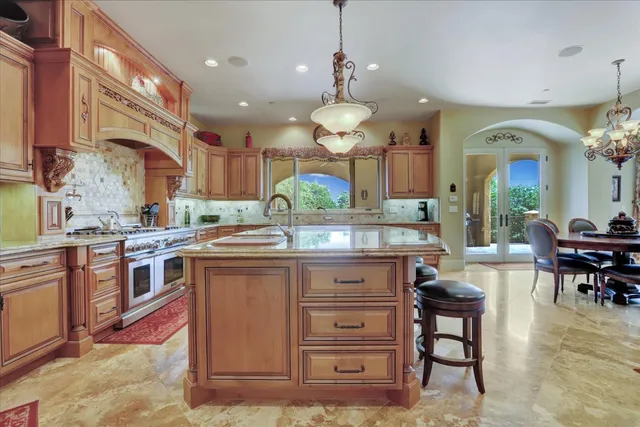 a dining room with furniture large windows and wooden floor