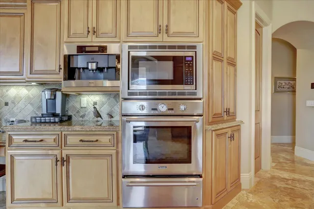 a spacious bedroom with a bed and a chandelier