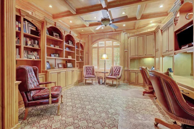 a dining room with furniture a flat screen tv and a large window