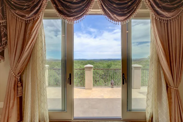 a backyard of a house with a yard and outdoor seating