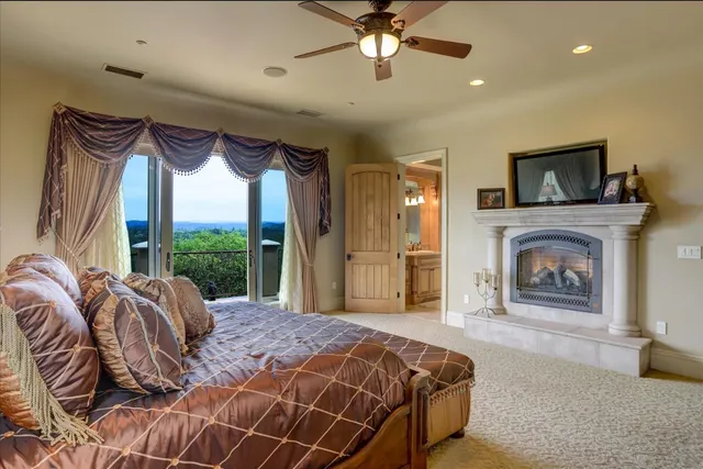 a kitchen with stainless steel appliances kitchen island granite countertop a dining table chairs and a refrigerator