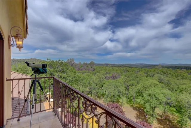 an aerial view of a house with a big yard