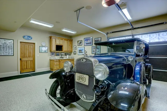 a front view of a house with a yard and a garage