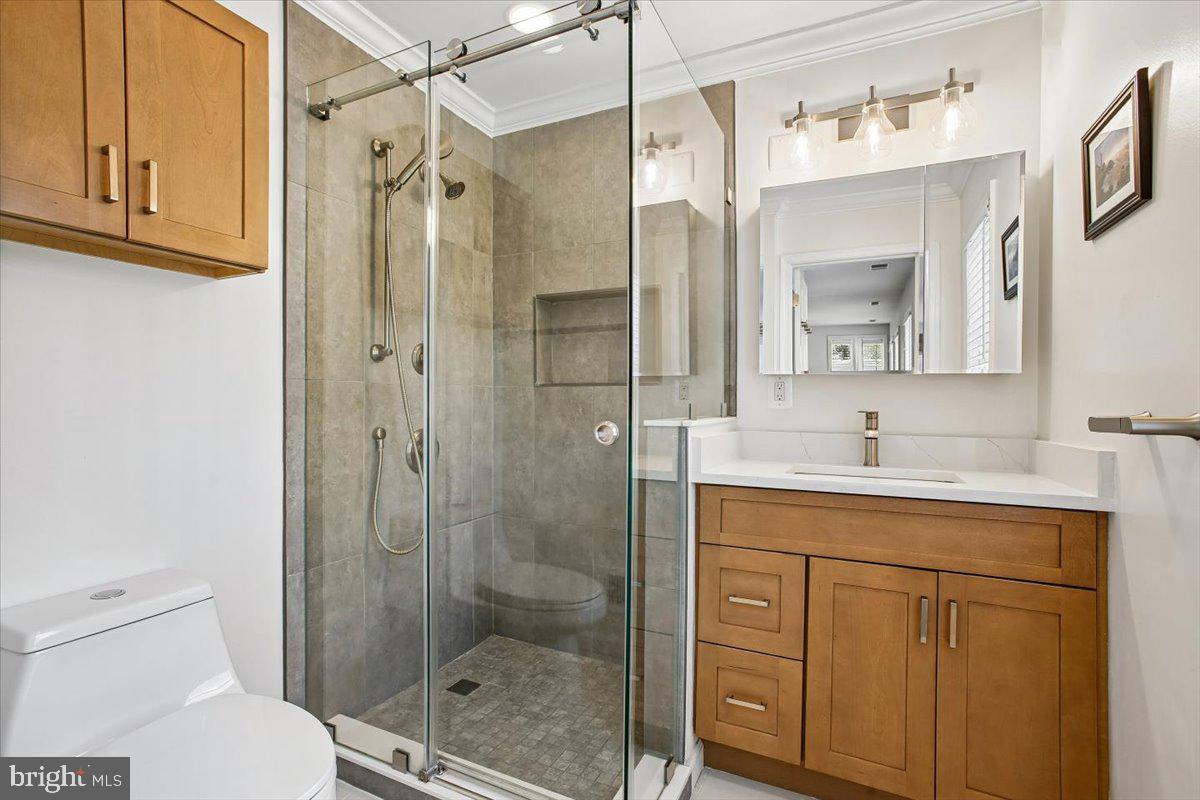1305 Key Drive Alexandria, VA 22302 - Photo 23 of 64 a bathroom with a shower a sink and mirror
