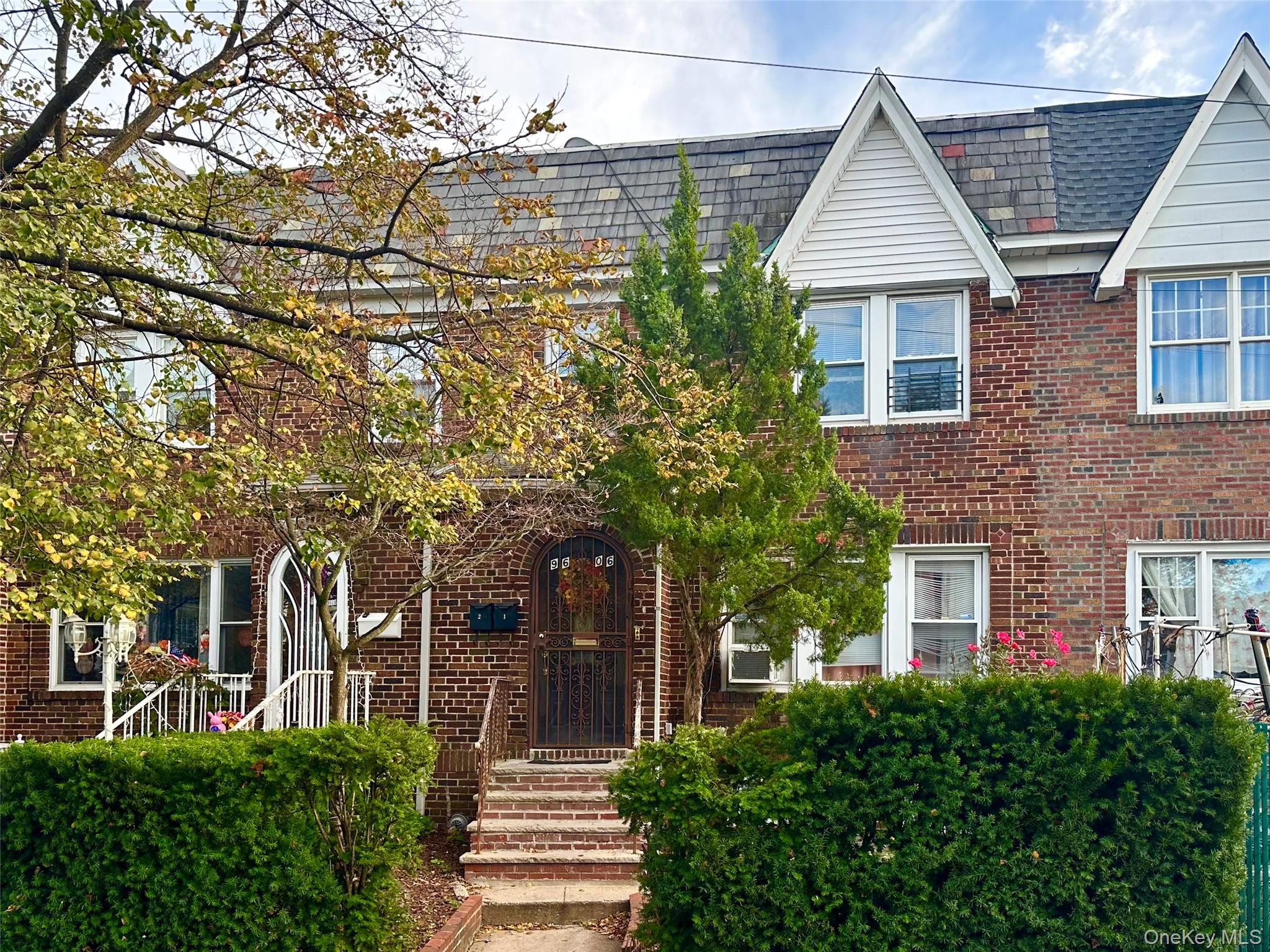 front view of a house with a tree