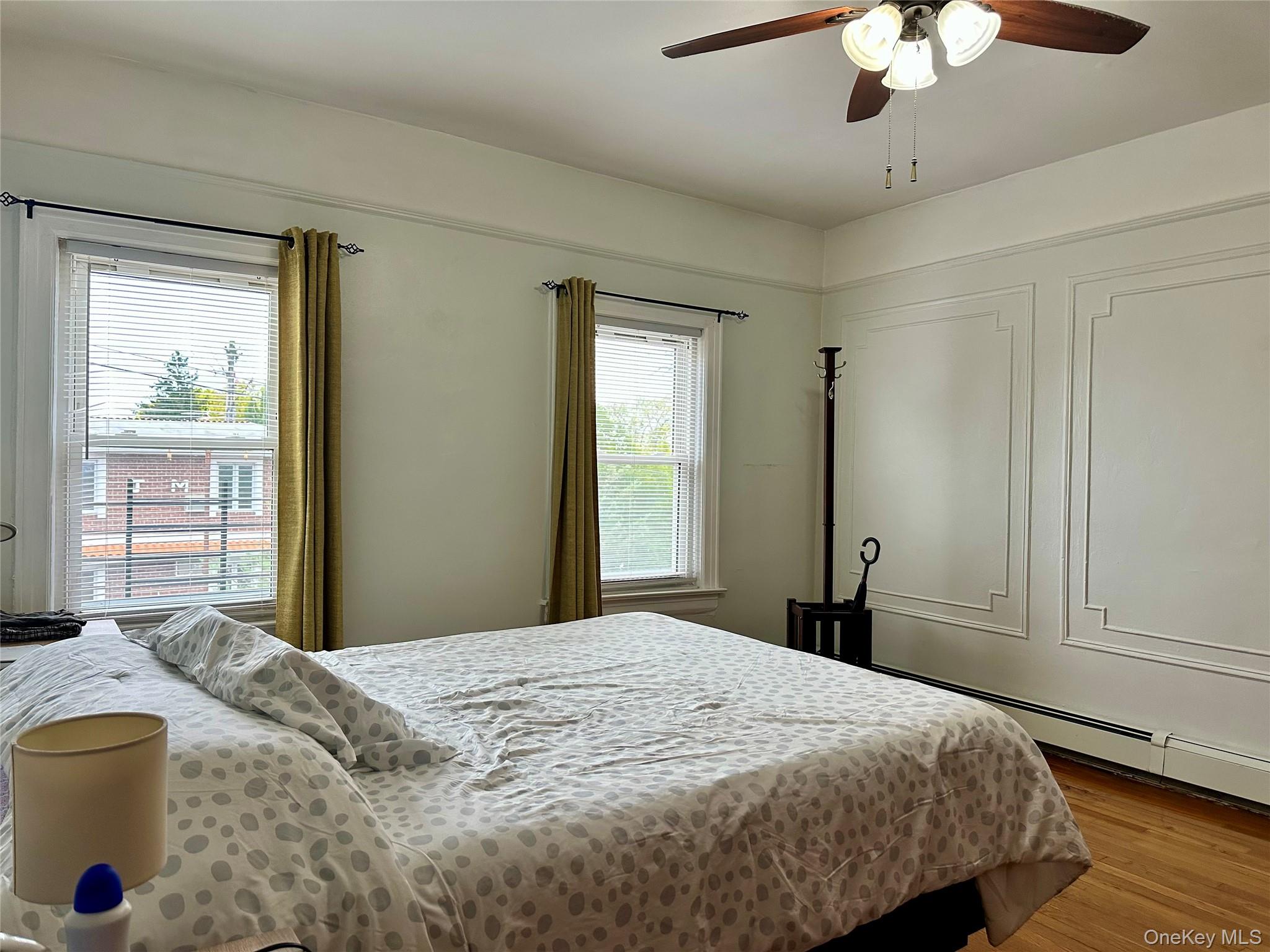 96-06 134th Road Queens, NY 11417 - Photo 4 of 11 a bedroom with a large bed and a chandelier