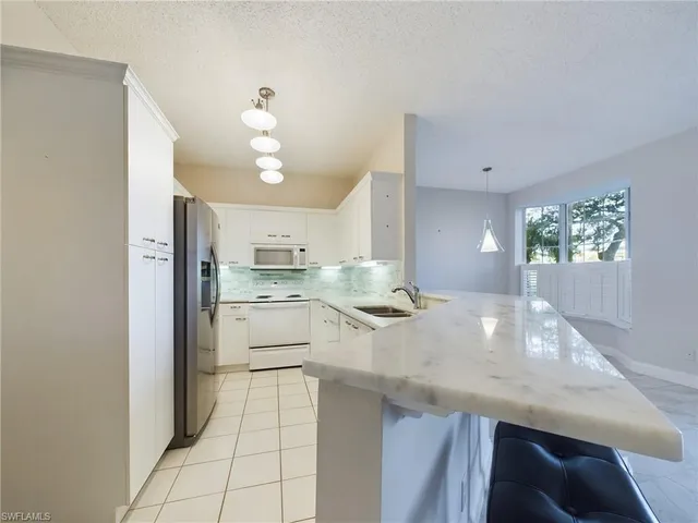 a kitchen with a sink cabinets and window