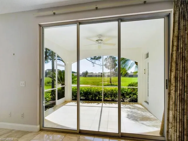 a view of a room with a floor to ceiling window and an outdoor view
