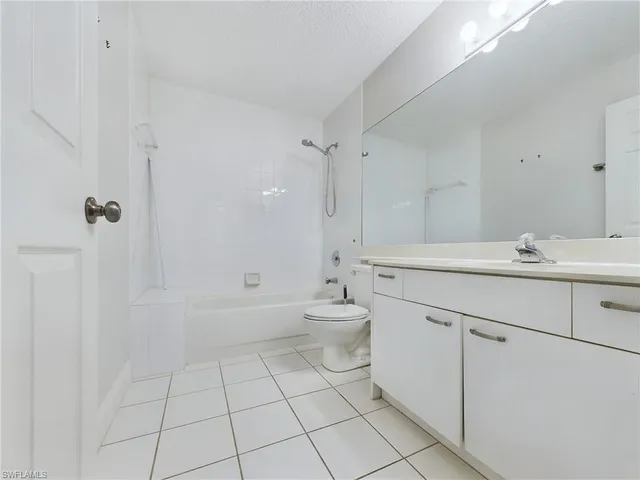 a bathroom with a double vanity sink toilet and shower