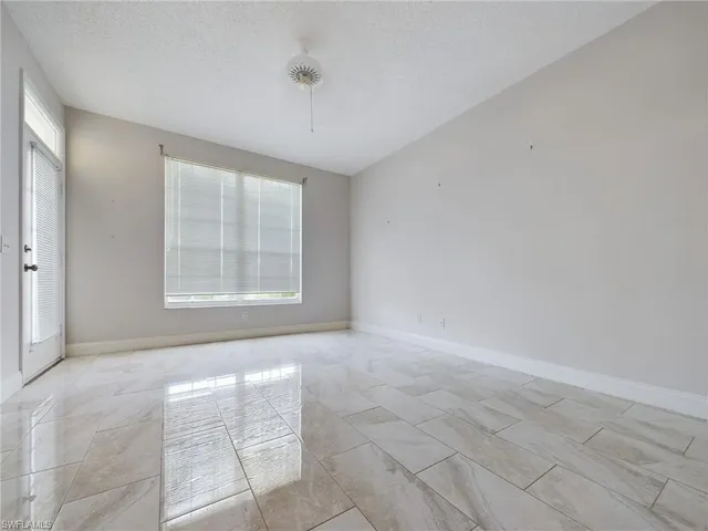 a view of an empty room with a window