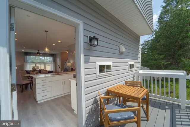 a view of a patio with a table and chairs