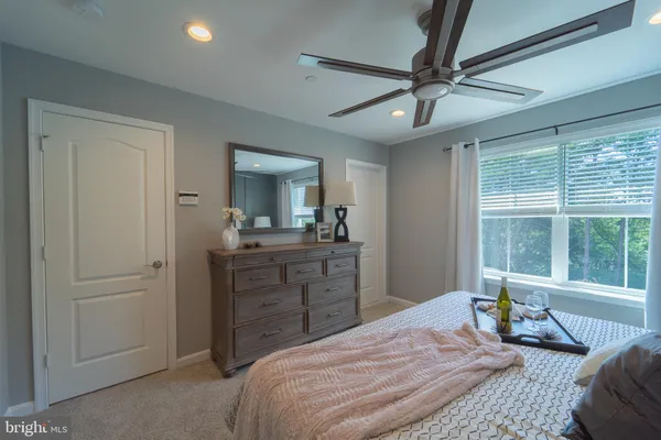 a bedroom with a large bed and a window