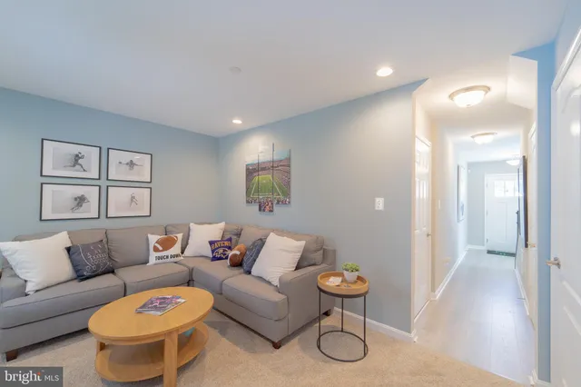 a living room with furniture and a painting