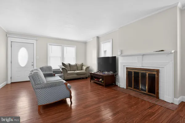a living room with furniture flat screen tv and a fireplace