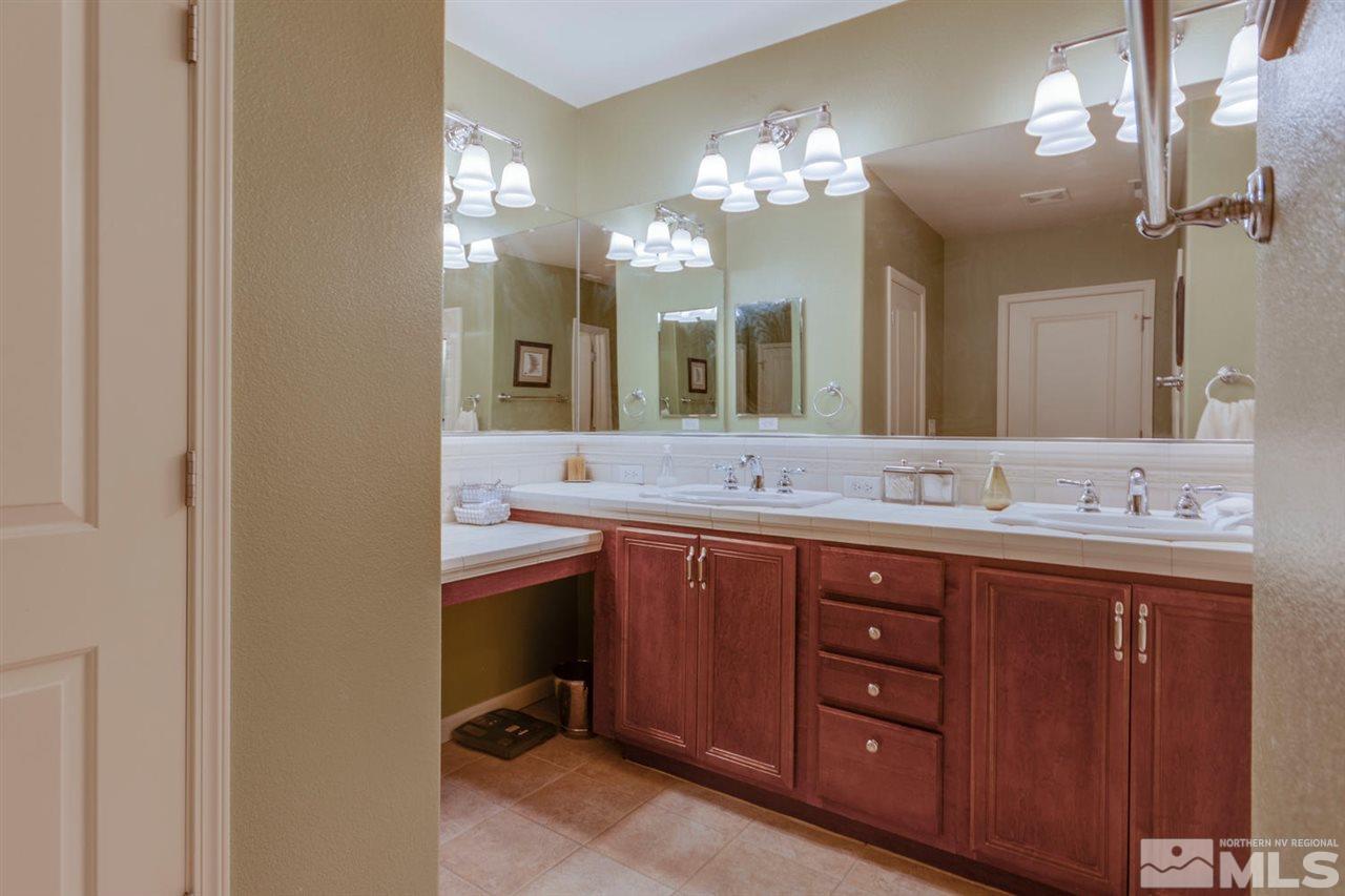 7660 Stone Bluff Way Reno, NV 89523 - Photo 16 of 22 a bathroom with a double vanity sink and a mirror