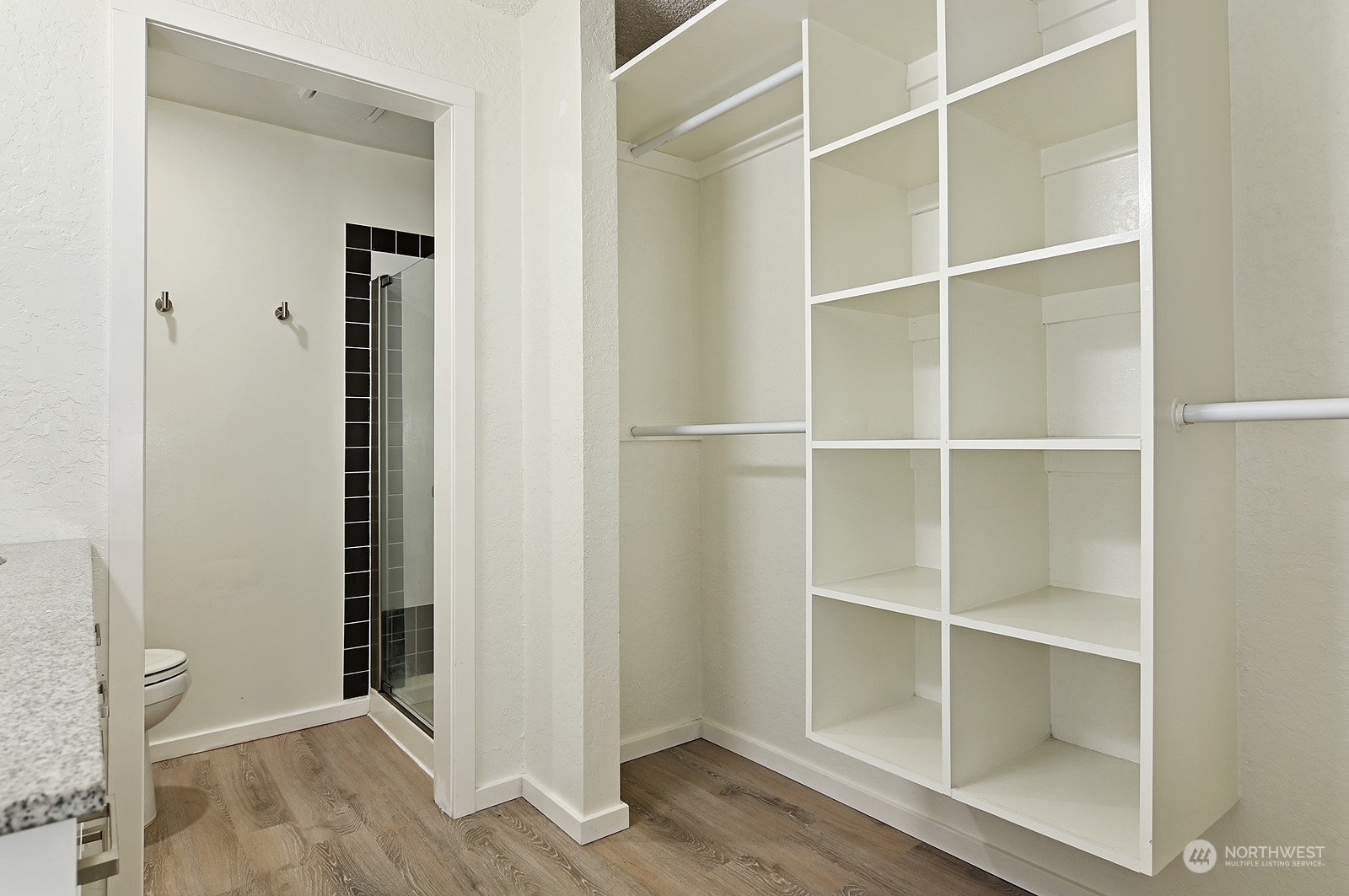 14401 Southeast Petrovitsky Road, Unit D105 Renton, WA 98058 - Photo 15 of 25 a view of an empty room with wooden floor and closet