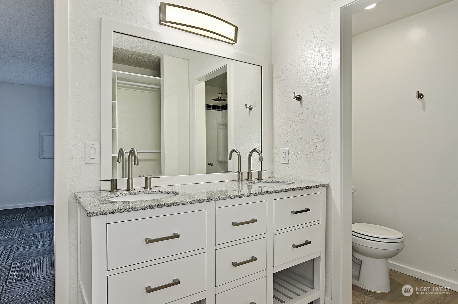 14401 Southeast Petrovitsky Road, Unit D105 Renton, WA 98058 - Photo 16 of 25 a bathroom with a granite countertop toilet sink and mirror