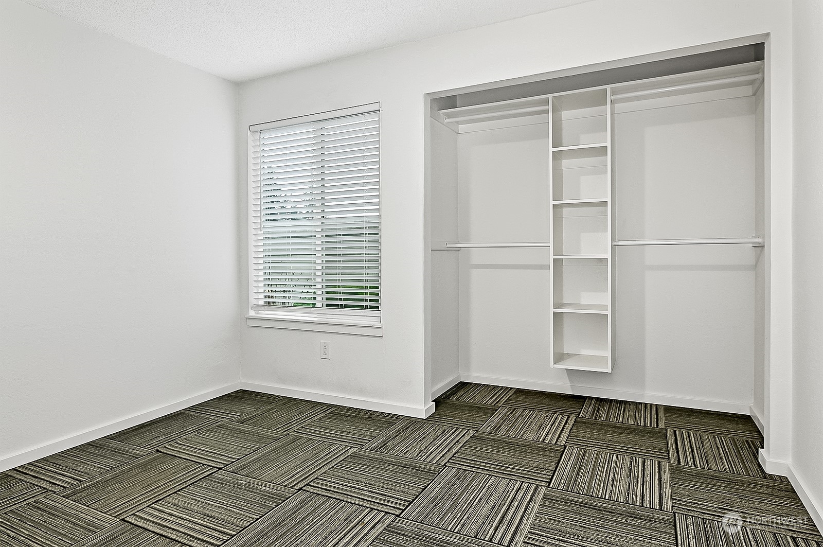 14401 Southeast Petrovitsky Road, Unit D105 Renton, WA 98058 - Photo 18 of 25 a view of an empty room with wooden floor and a window