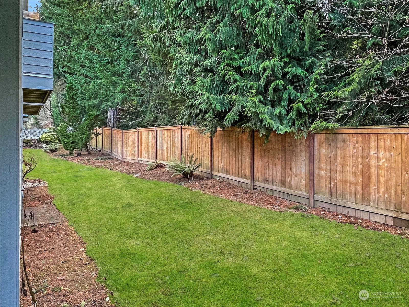 14401 Southeast Petrovitsky Road, Unit D105 Renton, WA 98058 - Photo 20 of 25 a view of a backyard with potted plants and wooden fence