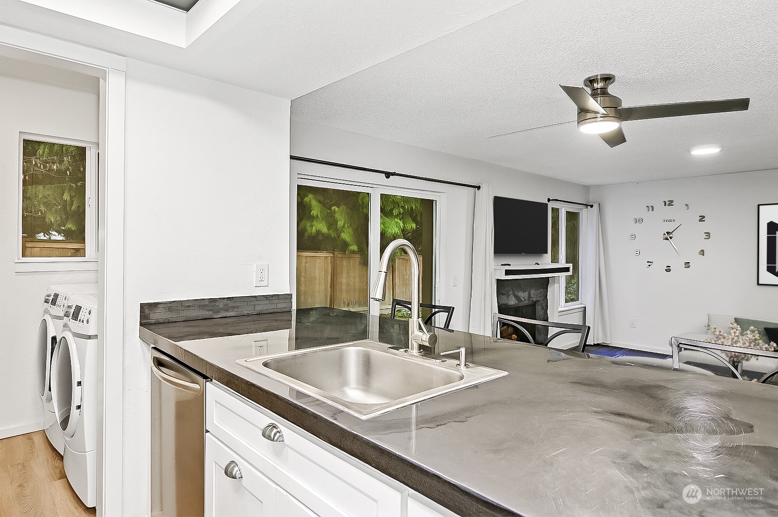 14401 Southeast Petrovitsky Road, Unit D105 Renton, WA 98058 - Photo 8 of 25 a kitchen with granite countertop a sink and a stove top oven
