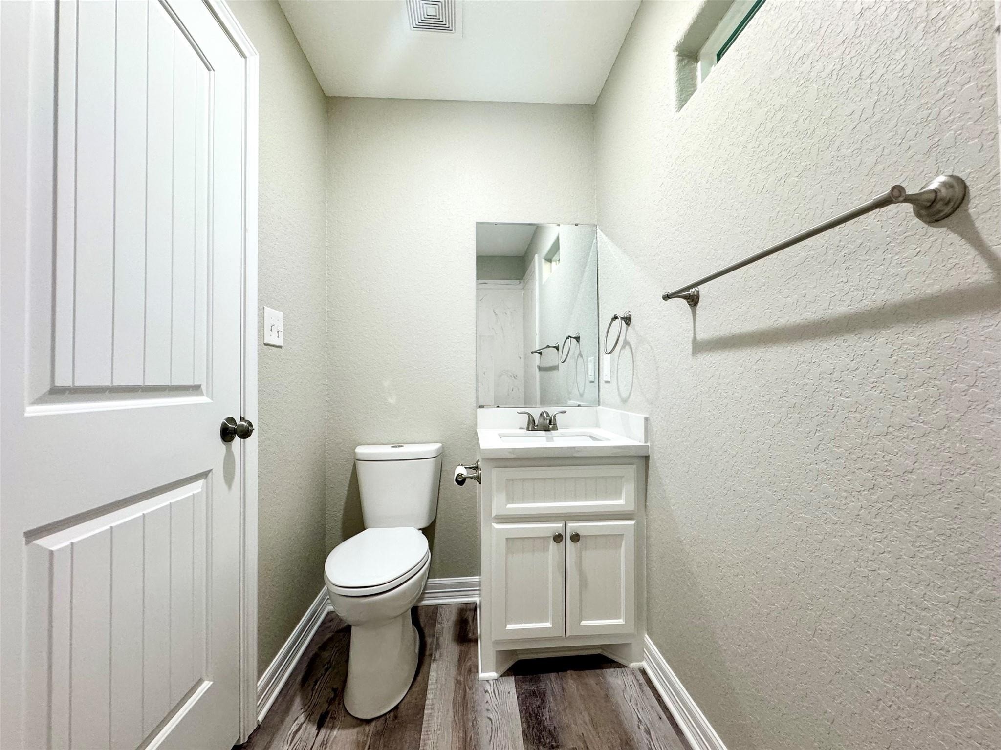 511 Caisson Street Surfside Beach, TX 77541 - Photo 30 of 33 a bathroom with a toilet a sink and a window