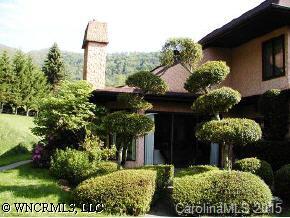 40 Wolfpen Road Waynesville, NC 28786 - Photo 5 of 9 a front view of a house with lots of plants and trees