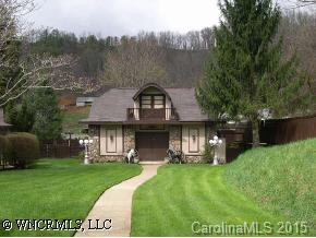 40 Wolfpen Road Waynesville, NC 28786 - Photo 8 of 9 a front view of a house with a garden and trees