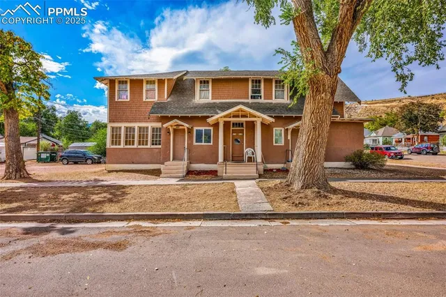 a front view of a house with a garden