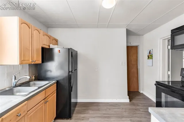 a kitchen with stainless steel appliances granite countertop a refrigerator and a sink