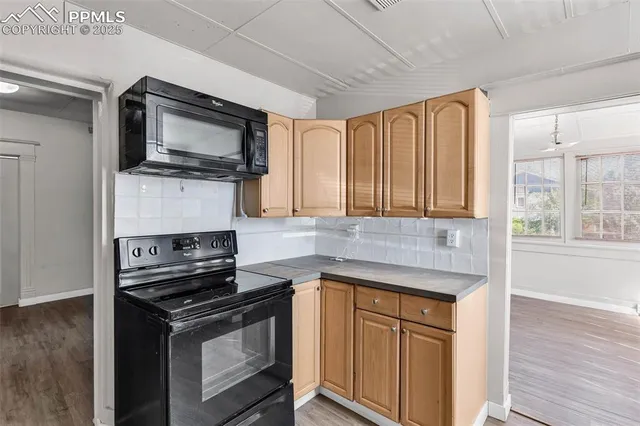 a kitchen with a stove microwave and sink