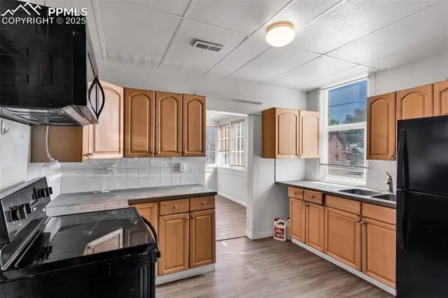 a kitchen with a sink appliances and cabinets