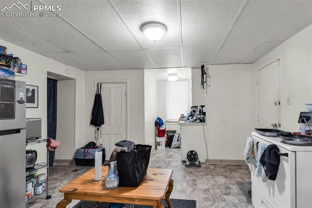 a view of a workspace with furniture and a flat screen tv