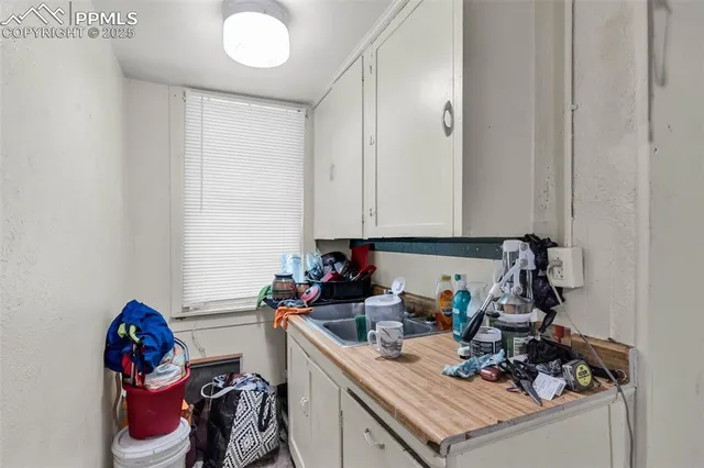 a kitchen with a sink cabinets and appliances