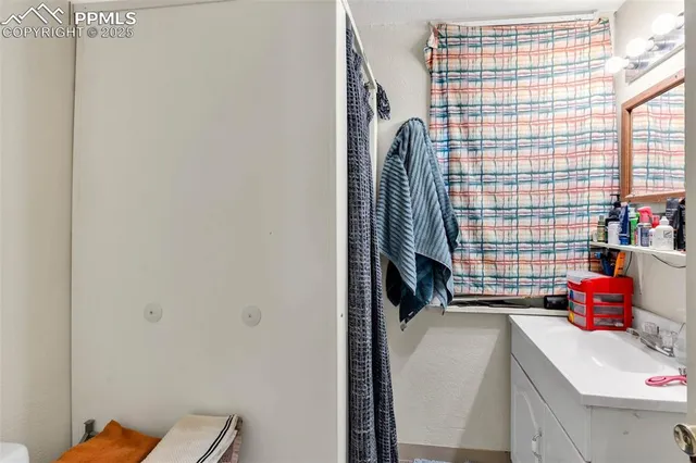 a bathroom with a sink and a shower curtain