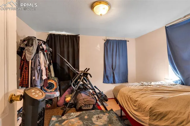 a bed sitting in a bedroom next to a window
