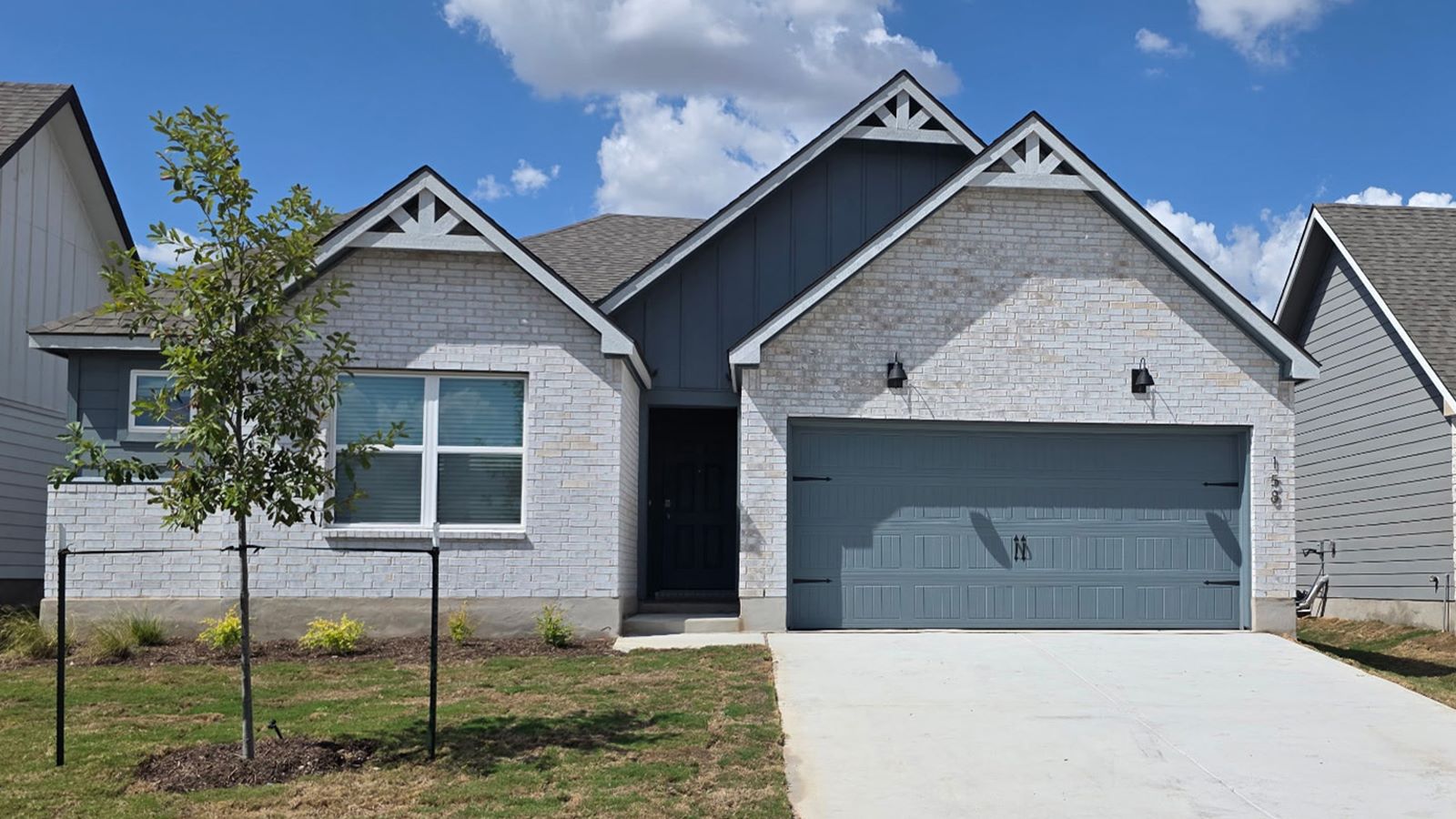 158 Candy Street Georgetown, TX 78626 - Photo 1 of 22 Gable rooflines and brick cladding define the facade of this single-story home.