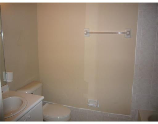 15630 Southwest 40th Street, Unit 192 Miramar, FL 33027 - Photo 7 of 10 a bathroom with a granite countertop sink and toilet