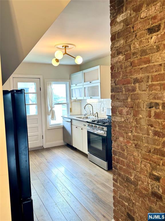 21 Valley Place, Unit 3 Edgewater, NJ 07020 - Photo 2 of 18 a kitchen with stainless steel appliances a refrigerator and a sink