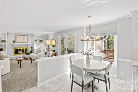 a dining room with furniture window and wooden floor